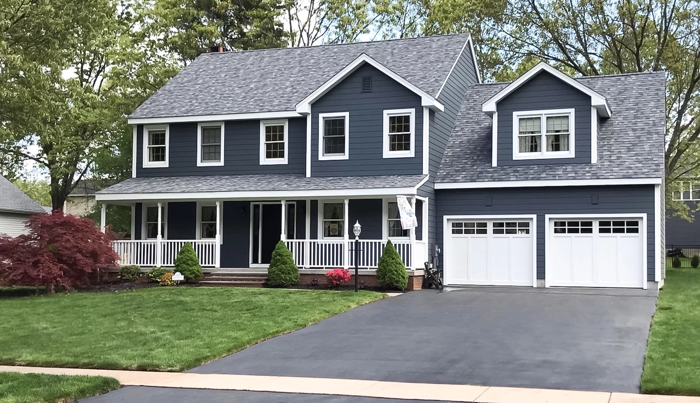 Blue Vinyl Siding installation and Roof replacement on a house in CT